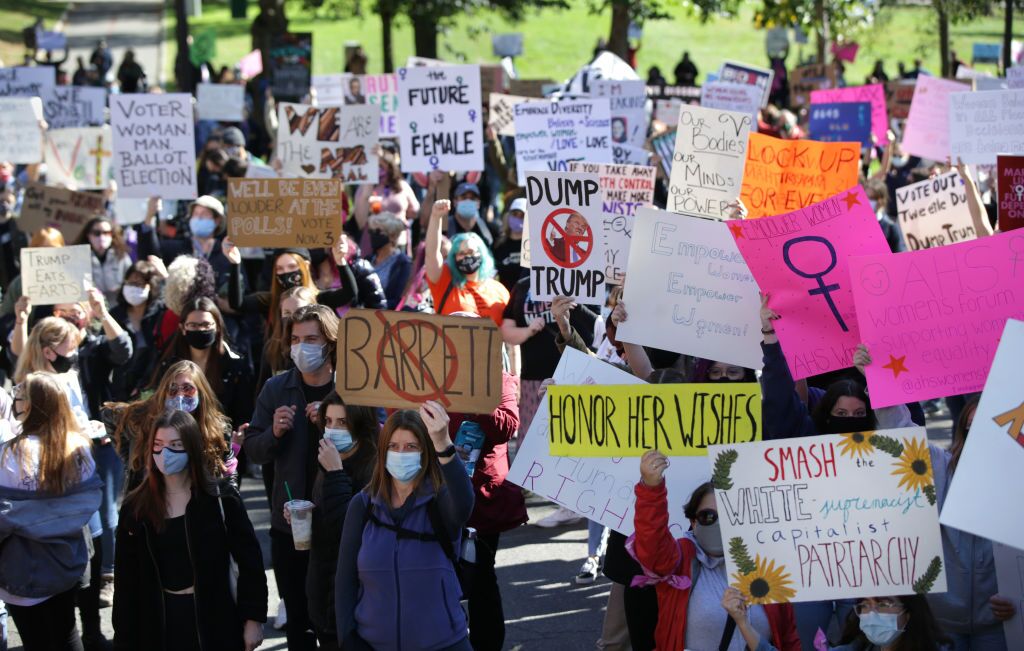 Holding signs such as "honor her wishes" and "smash the white supremacist capitalist patriarchy,"