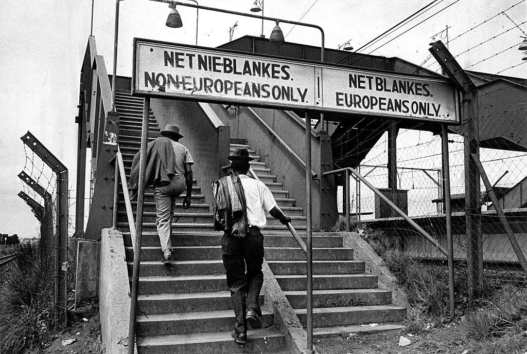 Photograph of segregational signs at a South African train station